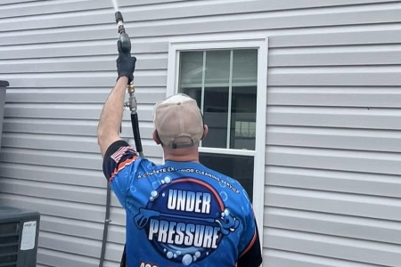 Under Pressure teechnician performing pressure washing at Newport TN residential property.